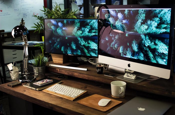 monitor and apple desktop on wooden desk