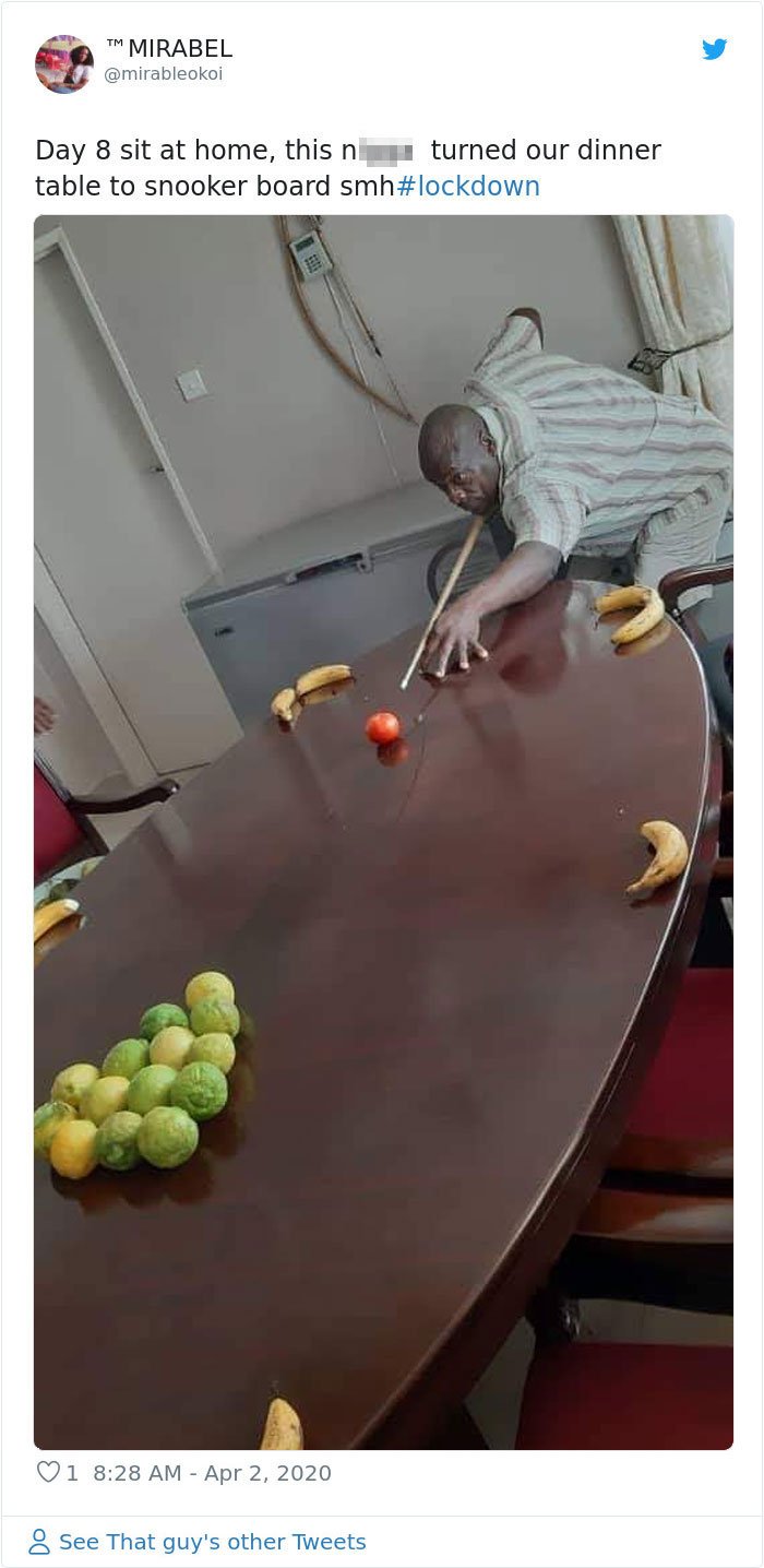 Man playing pool with fruit on kitchen table