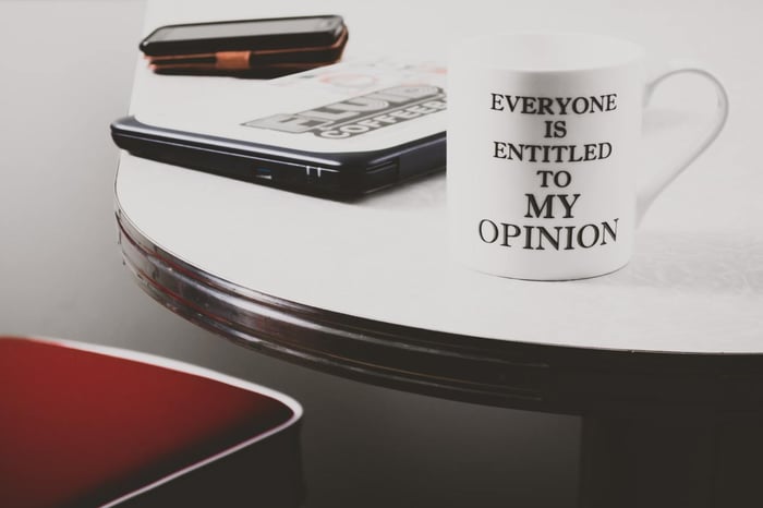 Opinion quote on a mug on a table
