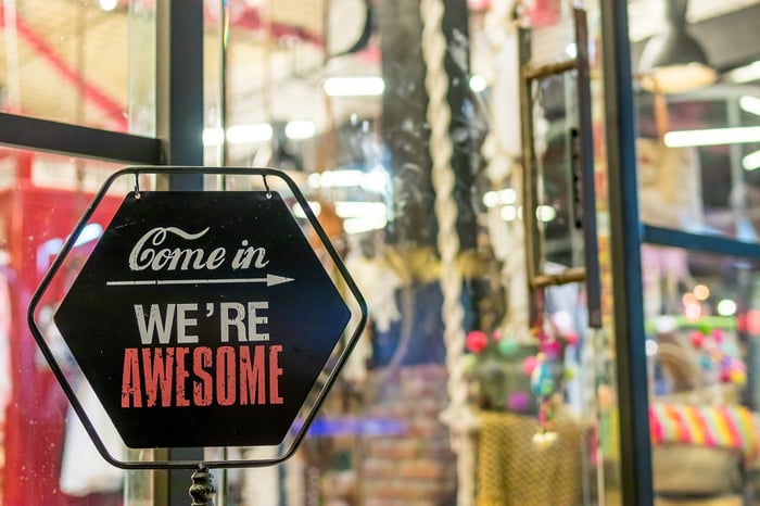sign on door saying "come in, we're awesome"
