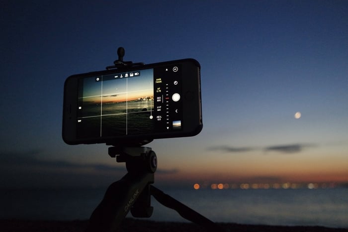 Smartphone taking photo on tripod at night