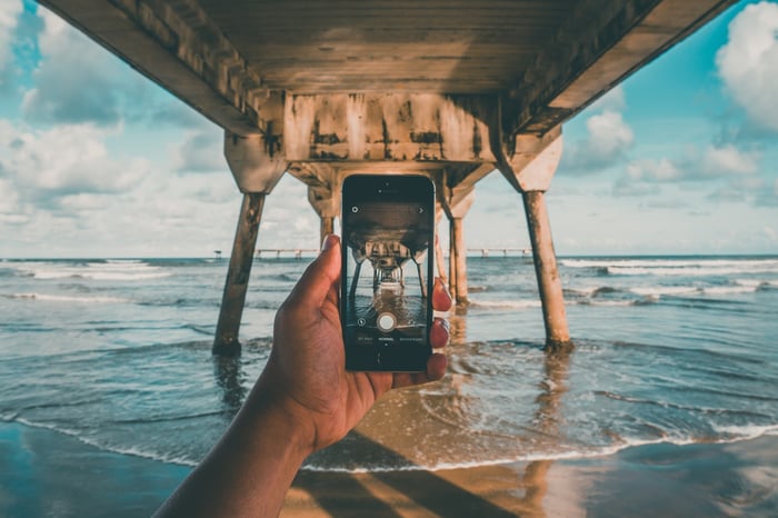 Mengambil foto dalam air di pantai di bawah jembatan