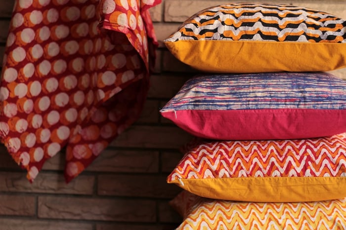 stack of vibrant printed cushions
