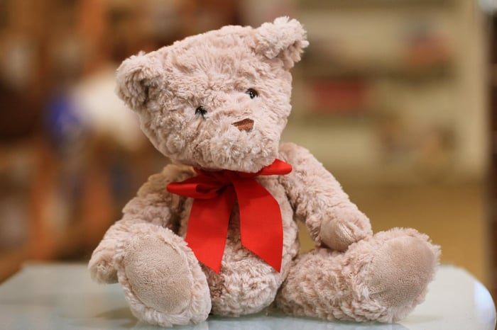 Teddy bear with a red bow sitting
