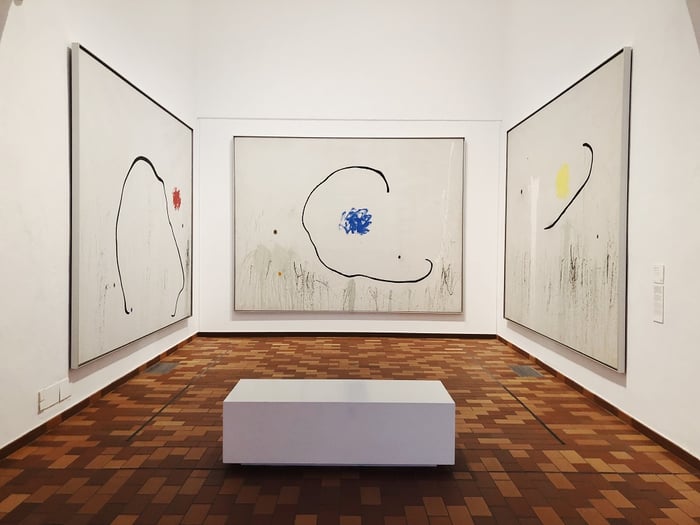 three large paintings in art gallery