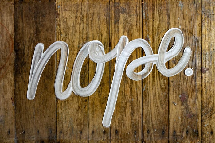 Nope spelled out against a wooden background