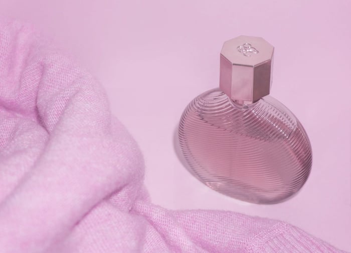 Pink perfume sweater product photography