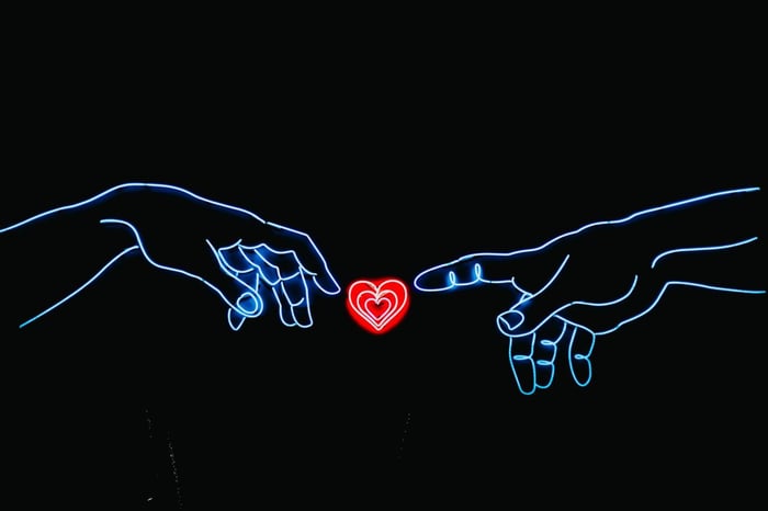 Neon sign two hands and heart