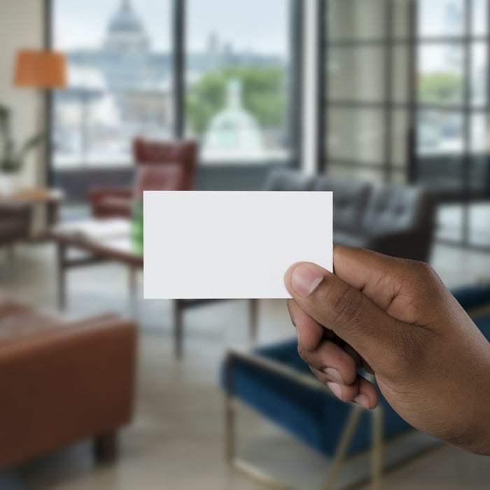 A person holding a blank business card
