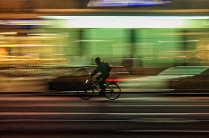 Person riding bicycle background blurry