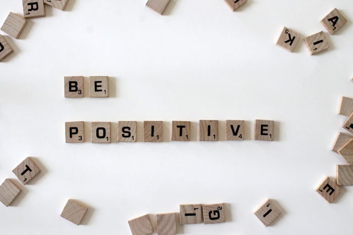 Wooden blocks spelling out be positive