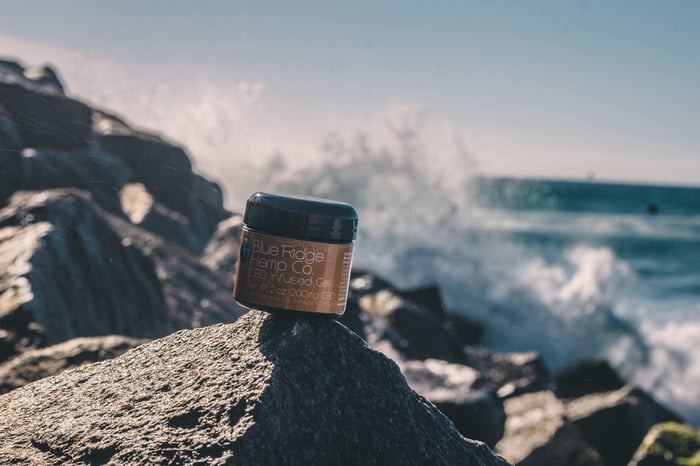 A beauty product on a stone by a beach