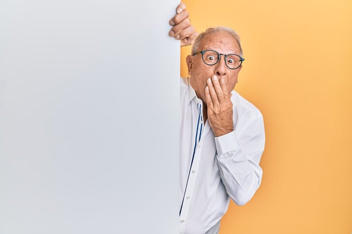 A man going oops against a yellow background
