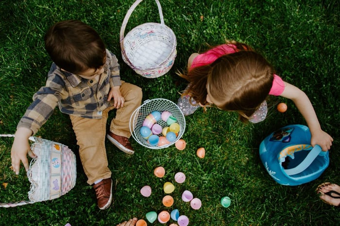 overhead shot of children counting Easter eggs out of baskets