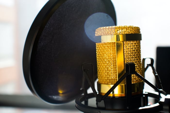 Golden microphone behind a screen