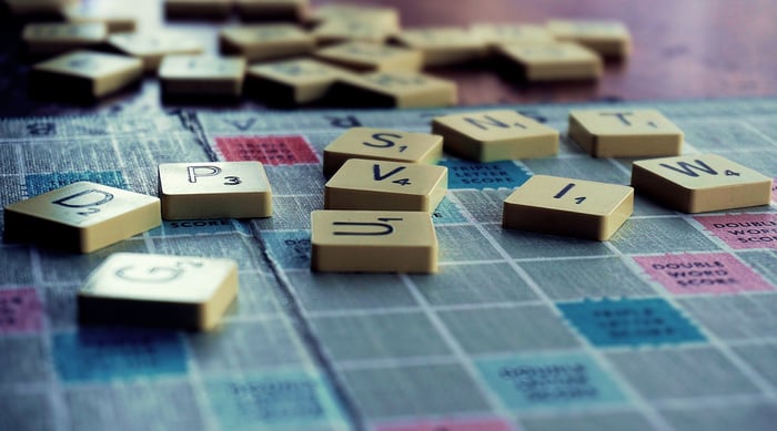 Scrabble pieces on a blue board