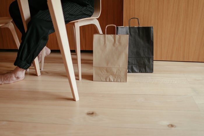 Shopping bags on the floor by a table